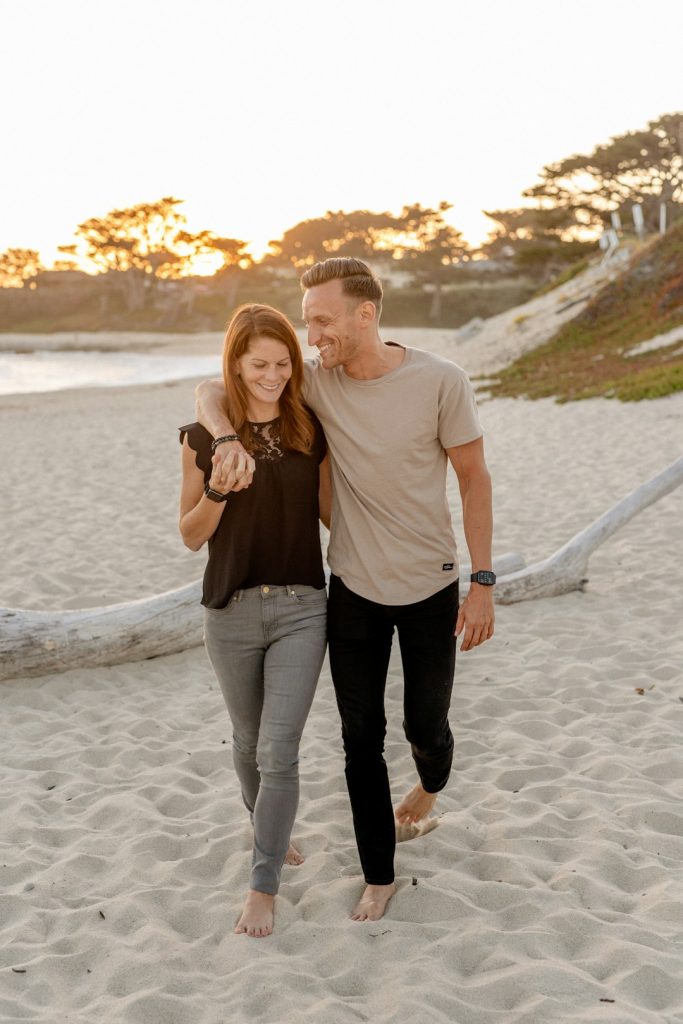 A couple walking together beside the sea